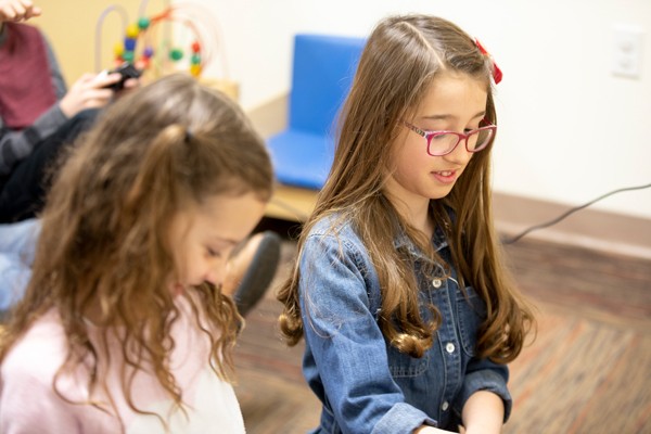 Two girls playing in a children's playroom