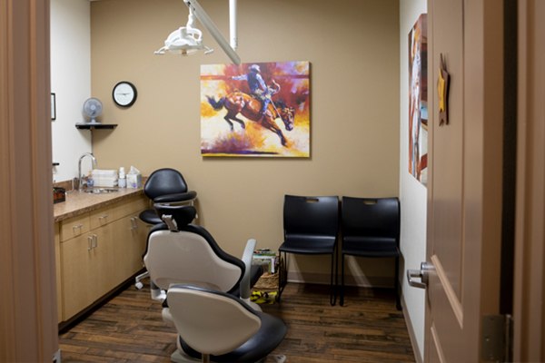 Dental office with horse painting on wall.