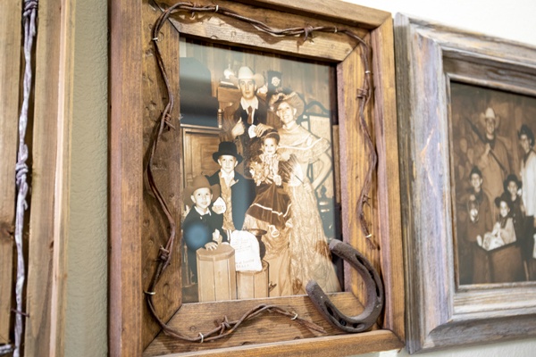 Vintage western family photo in rustic frame.