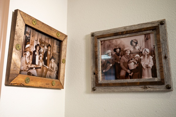 Framed vintage-style family portraits on wall.