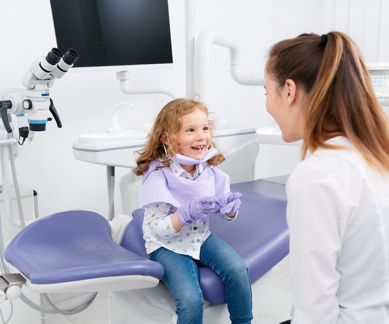 Child smiling at dentist's office.