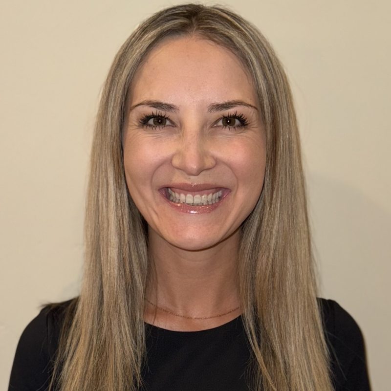 Smiling person with long blonde hair.